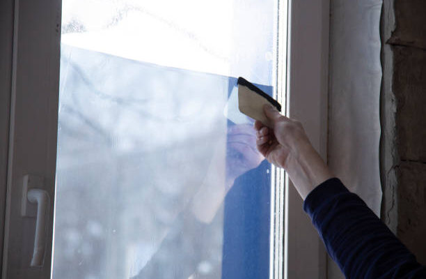 Installation of window film in the office. Protection from ultraviolet radiation.